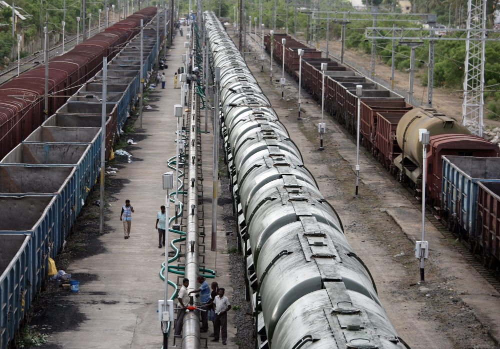 Technicians fix valves on a pipe before water is pumped into a tanker train, which will be transported and supplied to drought-hit city of Chennai, at Jolarpettai railway station in the southern state of Tamil Nadu, India, on Wednesday. — Reuters