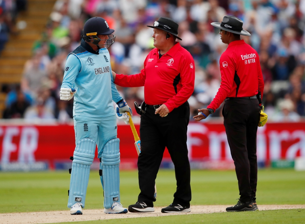 England's Jason Roy speaks with umpire Handunnettige Dharmasena and Marais Erasmus during the ICC Cricket World Cup semifinal against Australia at Edgbaston, Birmingham, Britain, on Thursday. — Reuters