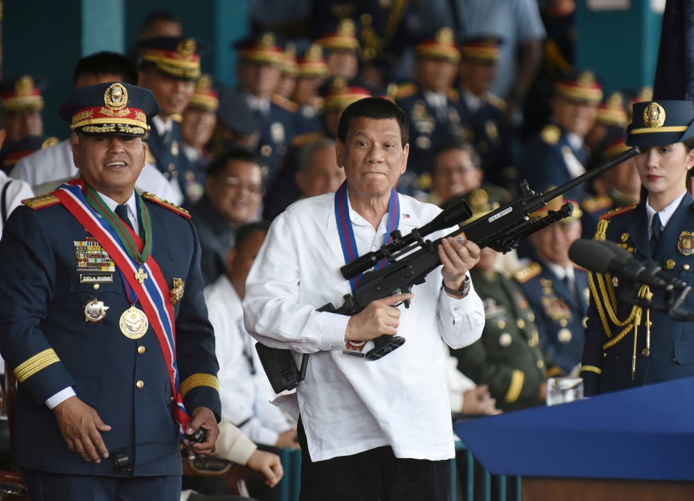 Philippine President Rodrigo Duterte holds a Galil sniper rifle next to outgoing Philippine National Police Chief Ronald Bato Dela Rosa during the National Police chief handover ceremony in Camp Crame, Quezon City, metro Manila, Philippines, in this April 19, 2018 file photo. — Reuters