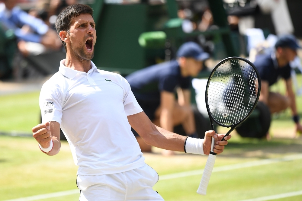 Serbia's Novak Djokovic celebrates beating Spain's Roberto Bautista Agut during their men's singles semi-final match on day 11 of the 2019 Wimbledon Championships at The All England Lawn Tennis Club in Wimbledon, southwest London, on Friday. — AFP