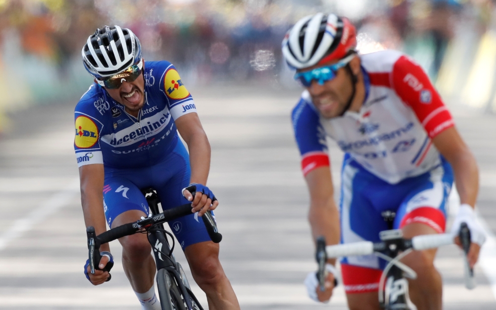 Deceuninck-Quick Step rider Julian Alaphilippe of France and Groupama-FDJ rider Thibaut Pinot of France finish the Tour de France 200-km Stage 8 from Macon to Saint-Etienne on Saturday. — AFP