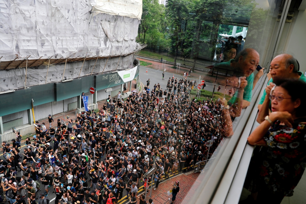 Anti-extradition bill protesters march at Sha Tin District of East New Territories, Hong Kong, on Sunday. -Reuters