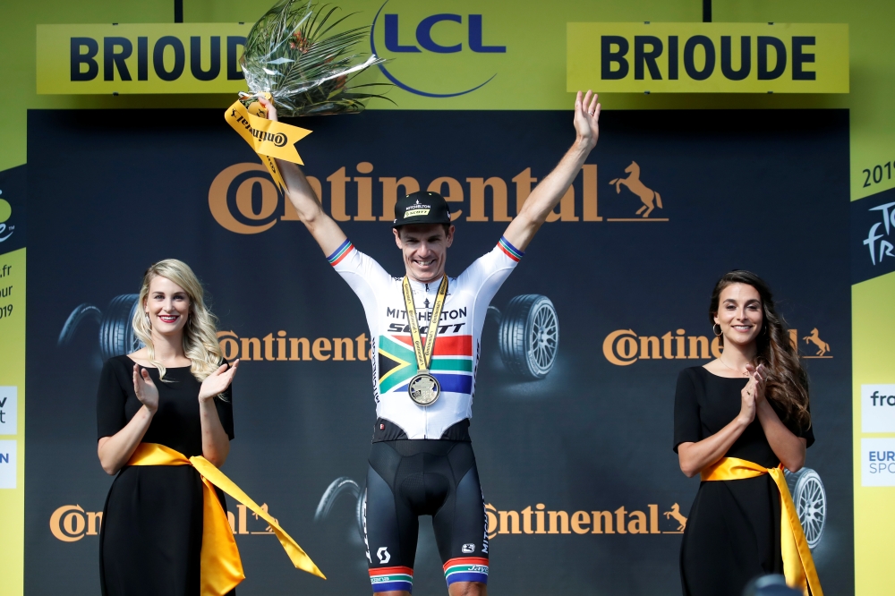 Mitchelton-Scott rider Daryl Impey of South Africa celebrates winning the Tour de France Stage 9 from Saint-Etienne to Brioude on the podium, on Sunday. — Reuters