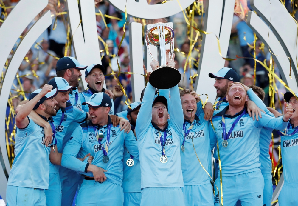 England's Eoin Morgan and teammates celebrate winning the world cup with the trophy after beating New Zealand in the ICC Cricket World Cup Final at  Lord's, London, Britain, on Sunday. — Reuters