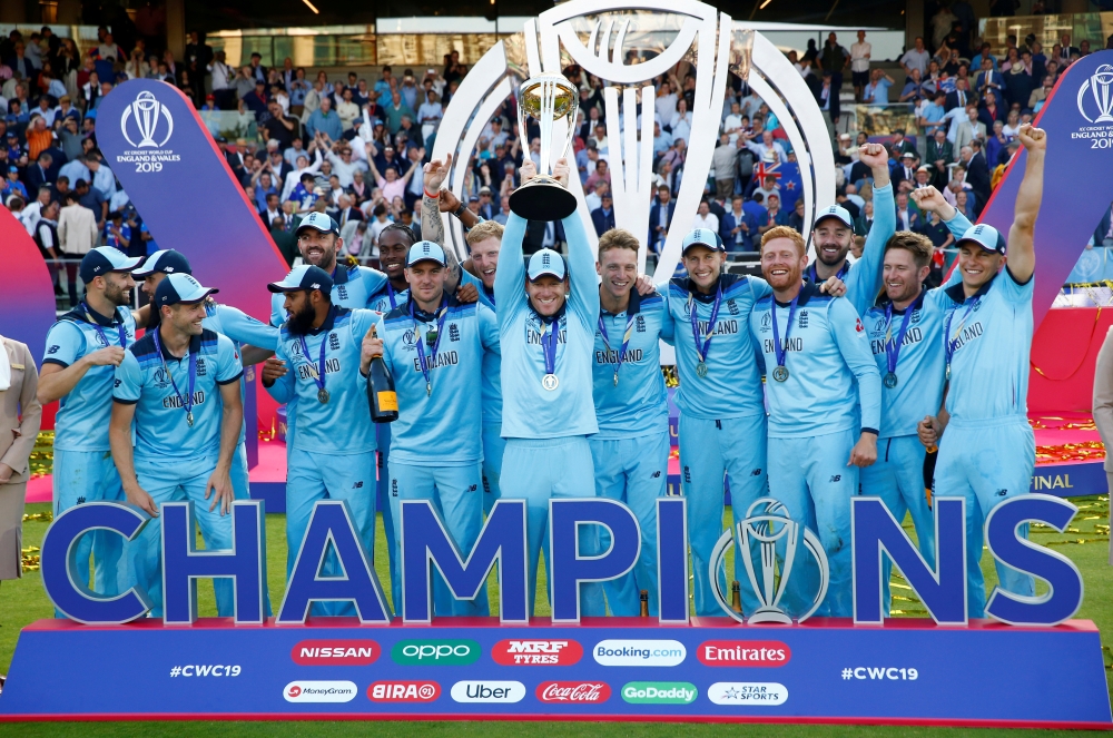 England's Eoin Morgan and teammates celebrate winning the World Cup with the trophy at Lord's, London, on Sunday. — Reuters