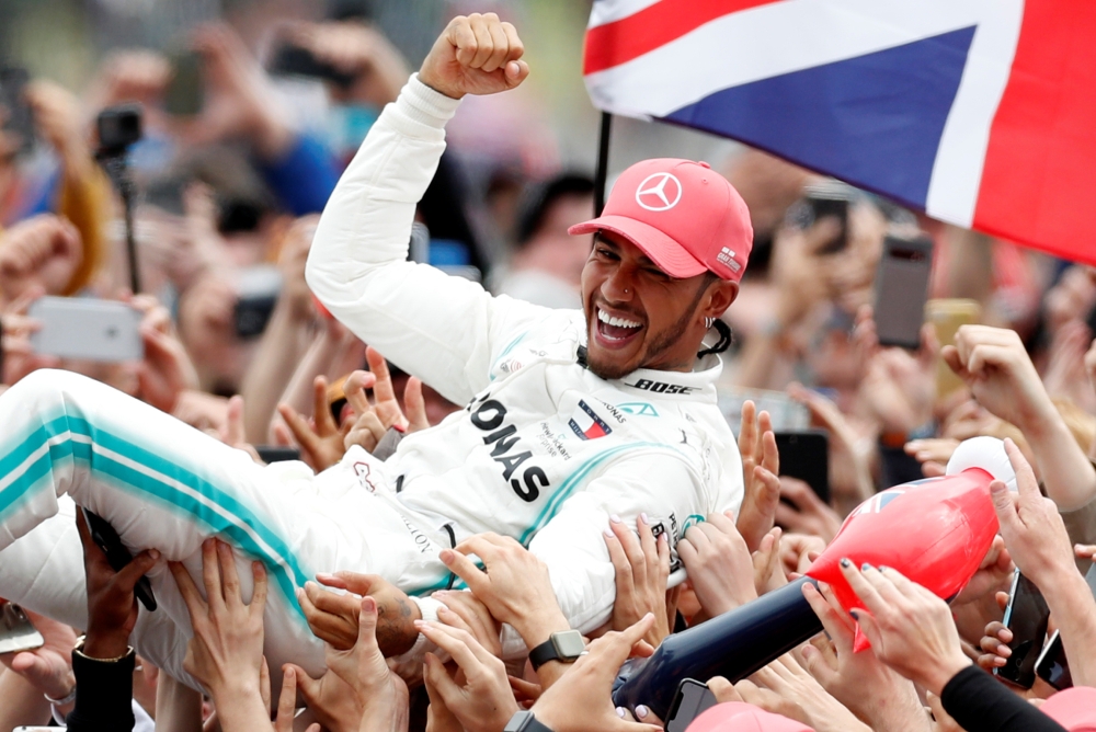 Mercedes' Lewis Hamilton celebrates with the crowd after winning the F1 British Grand Prix race at Silverstone Circuit, Silverstone, Britain, on Sunday. — Reuters