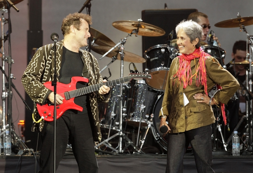 In this file photo taken on June 27, 2008 South African singer-songwriter Johnny Clegg (L) and US singer Joan Baez perform during the 46664 concert in honor of Nelson Mandela's 90th birthday in Hyde Park, central London. — AFP