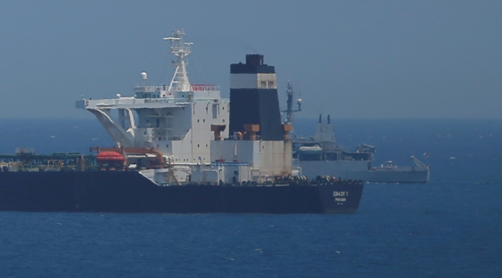 A British Royal Navy patrol vessel guards the oil supertanker Grace 1, that's on suspicion of carrying Iranian crude oil to Syria, as it sits anchored in waters of the British overseas territory of Gibraltar, in this July 4, 2019 file photo. — Reuters
