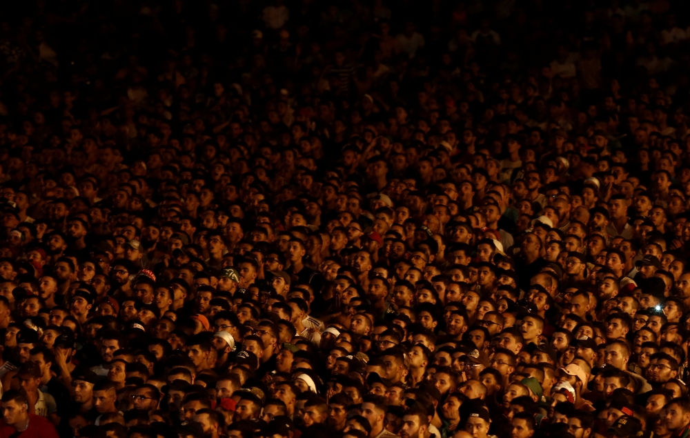 Sarah, 20, reacts while watching a Guinea counter-attack against Algeria on screen during the Africa Cup of Nations 2019 (Afcon), in Algiers, Algeria July 7, 2019. — Reuters