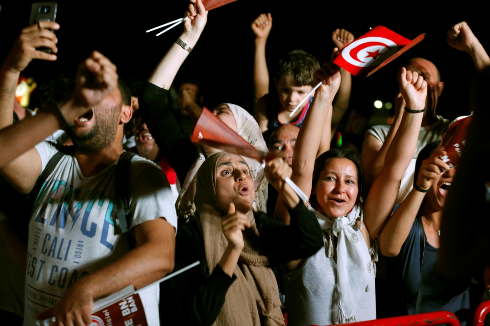 Sarah, 20, reacts while watching a Guinea counter-attack against Algeria on screen during the Africa Cup of Nations 2019 (Afcon), in Algiers, Algeria July 7, 2019. — Reuters