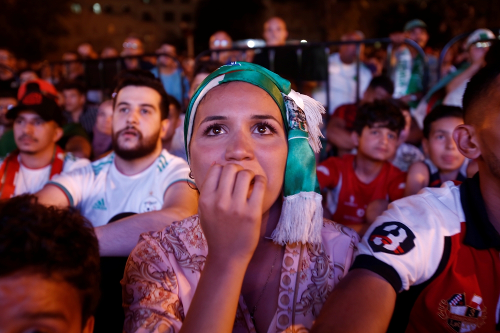 Sarah, 20, reacts while watching a Guinea counter-attack against Algeria on screen during the Africa Cup of Nations 2019 (Afcon), in Algiers, Algeria July 7, 2019. — Reuters