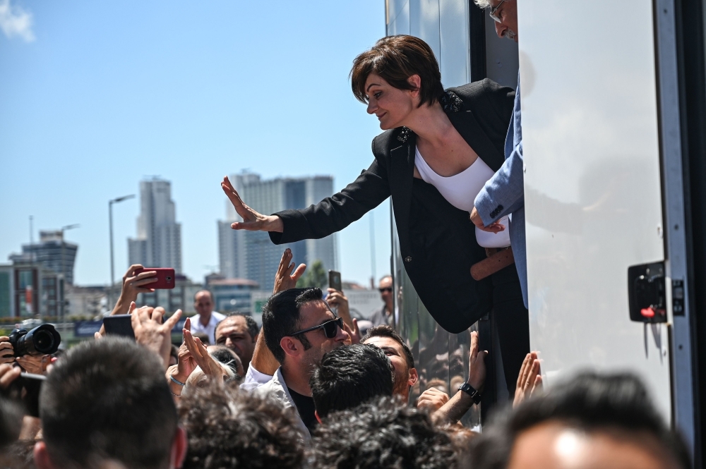 Republican People's Party (CHP) Istanbul chief Canan Kaftancioglu, right, waves to supporters as she stands on a stage to deliver a speech after her trial in Istanbul on Thursday. — AFP