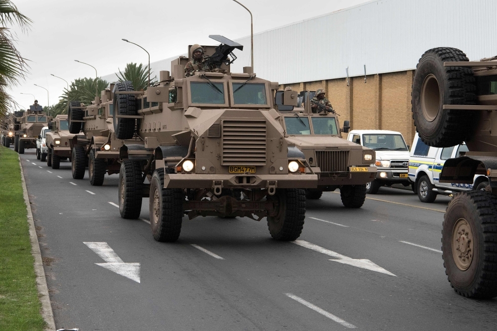 A convoy of South African National Defense Force (SANDF) drives through a street close to Manenberg in Cape Town on Thursday. — AFP