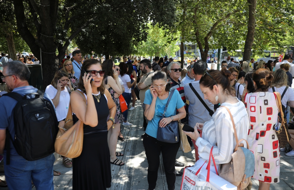 People are seen on the Syntagma Square following the evacuation of nearby buildings after an earthquake in Athens, Greece, on Friday. — Reuters