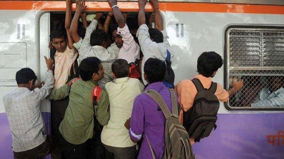 Passengers squeeze into an overcrowded train compartment in Mumbai in this file photo. — AFP