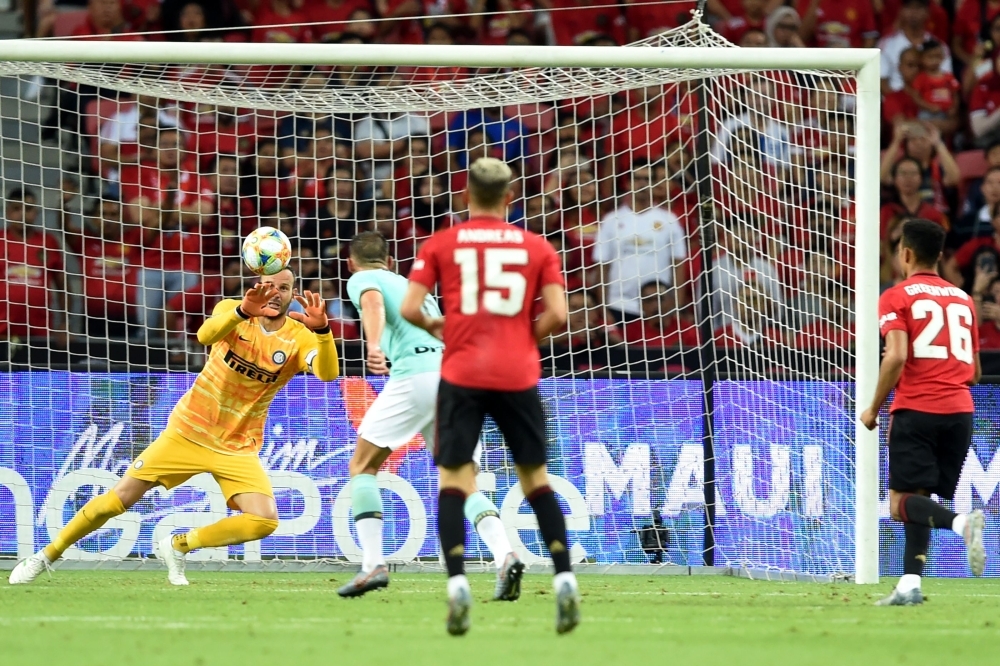 Inter Milan's Samir Handanovic (L) lets in a goal by Manchester United's Mason Greenwood (R) during the International Champions Cup football match between Manchester United and Inter Milan in Singapore, on Saturday. — AFP