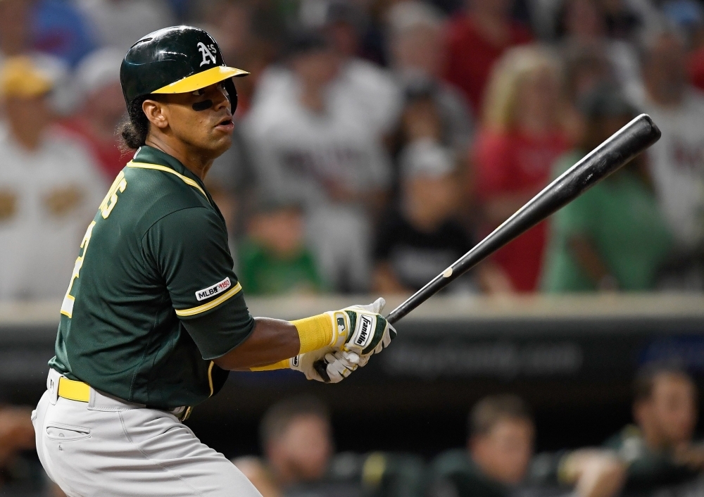 Khris Davis of the Oakland Athletics hits a two-run single against the Minnesota Twins during the ninth inning of the game at Target Field in Minneapolis, Minnesota, on Saturday. The Athletics defeated the Twins 5-4. — AFP