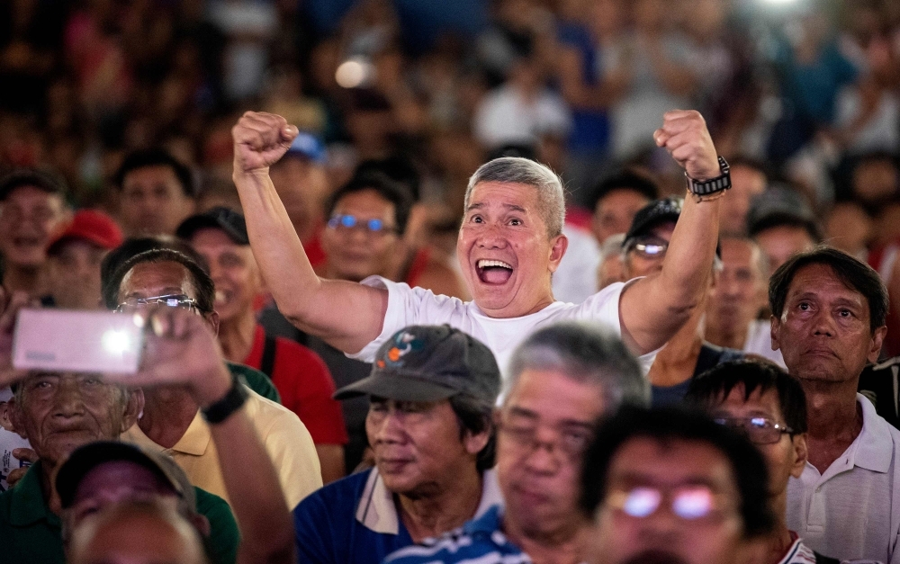 Filipino fans watch Philippines' Manny Pacquiao fight agains Keith Thurman from the US, at a covered basketball court in Manila on Sunday, during their world welterweight boxing championship in Las Vegas. Pacquiao rolled back the years with a vintage display to defeat reigning WBA welterweight champion Thurman by split decision in a thrilling 12-round battle. — AFP