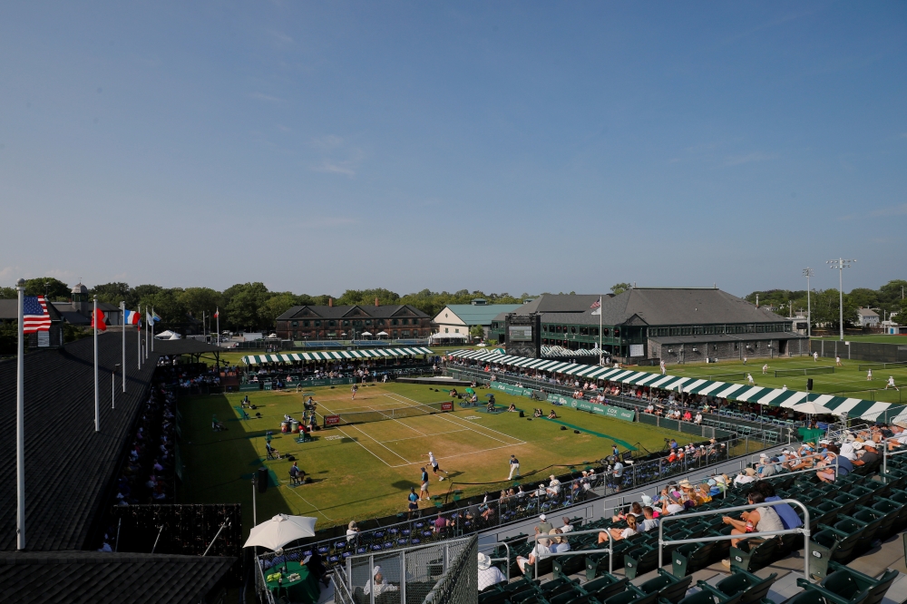 John Isner of the US and Ugo Humbert of France compete in a semi-final of the Hall of Fame Open at the International Tennis Hall of Fame in Newport, Rhode Island, US, on Saturady. — Reuters