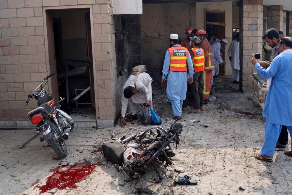 Rescue workers and police officers gather after a suicide blast at the premises of the Civil Hospital in Dera Ismail Khan, Pakistan on Sunday. -Reuters photo