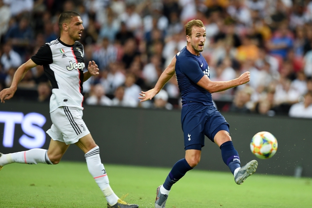 Tottenham Hotspur's Harry Kane (R) kicks the ball during the International Champions Cup football match between Juventus and Tottenham Hotspur in Singapore, on Sunday. — AFP