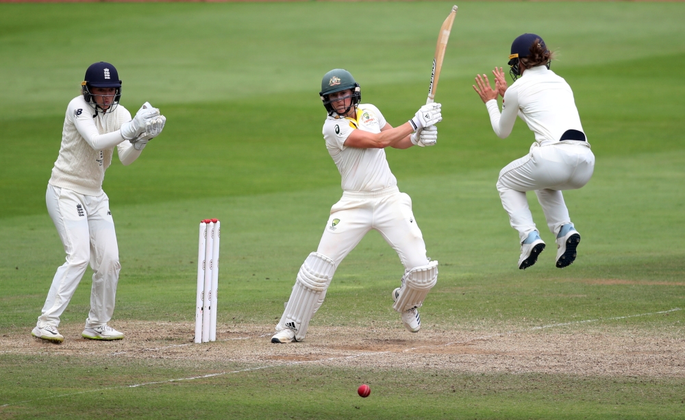 Australia's Ellyse Perry in action as England's Amy Jones jumps and England's Sarah Taylor looks on during the Women’s Ashes Test match against England at the Coopers Associates County Ground, Taunton, Britain, on Sunday. — Reuters   