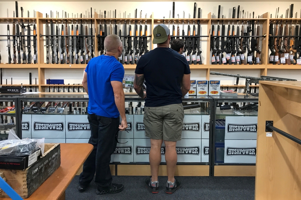 People look at firearms and accessories on display at Gun City gun shop in Christchurch, New Zealand, in this March 19, 2019 file photo. — Reuters