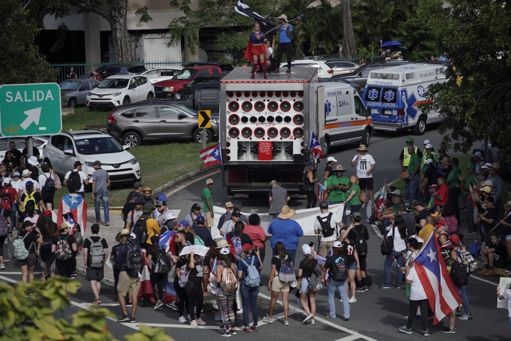 People take to the Las Americas Highway in San Juan, Puerto Rico, on Monday on day 9th of continuous protests demanding the resignation of Governor Ricardo Rossellَ. — AFP