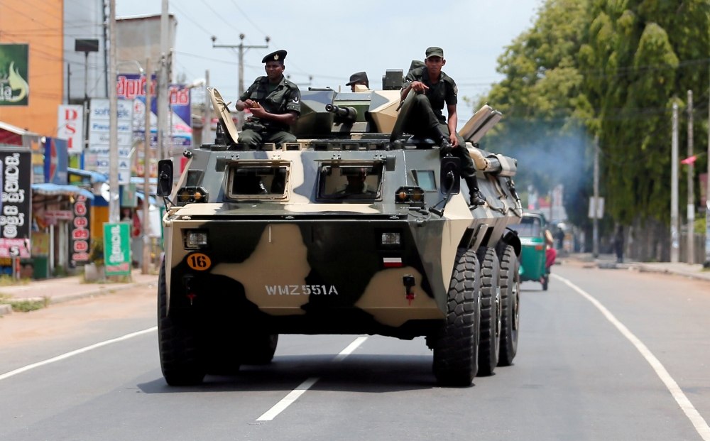 Sri Lankan soldiers patrol a road of Hettipola after a mob attack in a mosque in the nearby village of Kottampitiya, Sri Lanka, in this May 14, 2019 file photo. — Reuters