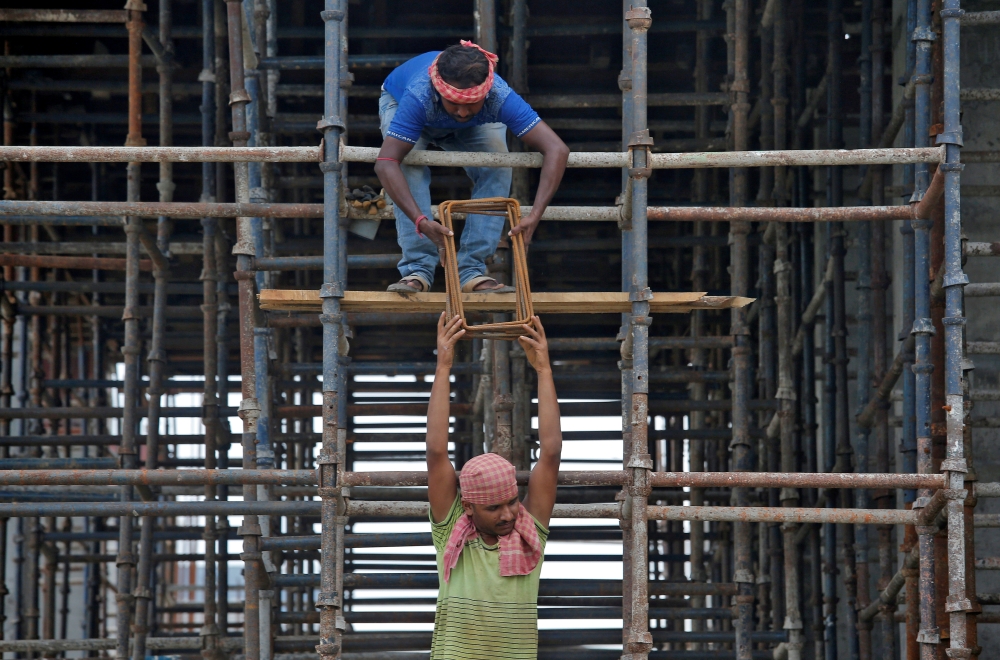 Laborers work at the construction site of a residential building on the outskirts of Kolkata, India, in this July 5, 2019 file photo. — Reuters