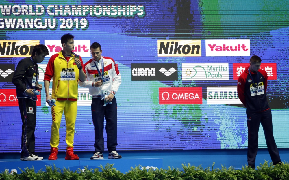 Gold medalist Sun Yang of China (C) reacts on podium next to silver medalist Katsuhiro Matsumoto of Japan and joint bronze medalists Martin Malyutin of Russia and Duncan Scott of Britain at the World Swimming Championships men's 200m freestyle victory ceremony at Nambu University Municipal Aquatics Center, Gwangju, South Korea, on Tuesday. — Reuters