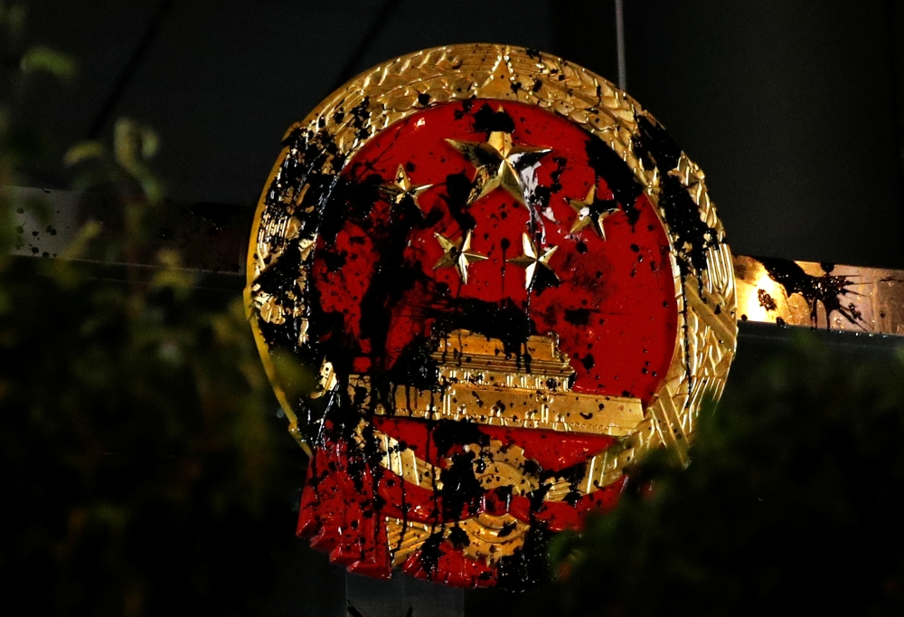 The National Emblem of the People's Republic of China is seen vandalized on the Chinese Liaison Office after a march to call for democratic reforms, in Hong Kong, China, in this July 21, 2019 file photo. — Reuters