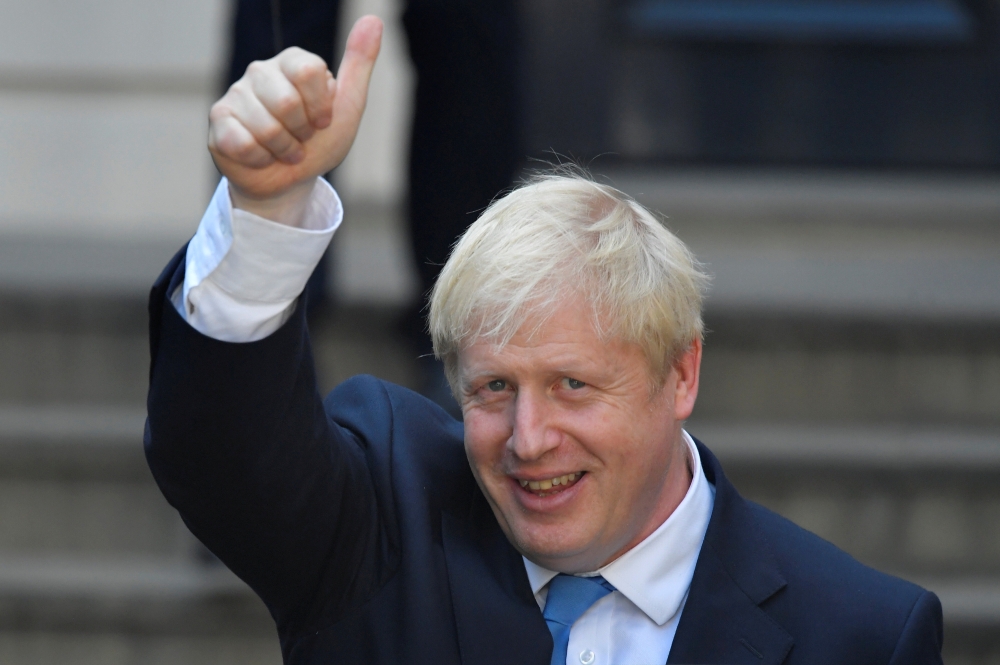 Boris Johnson, leader of the Britain's Conservative Party, leaves the party's headquarters in London, Britain, on Tuesday. — Reuters