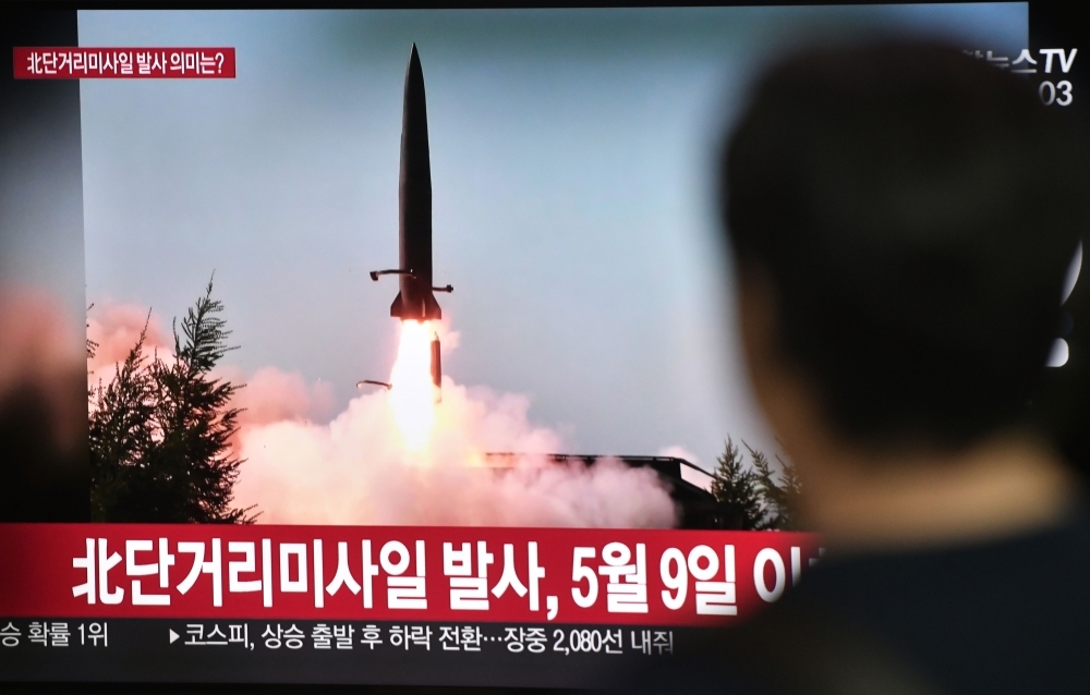 A man watches a television news screen showing a file footage of a North Korean missile launch at a railway station in Seoul on Thursday. — AFP