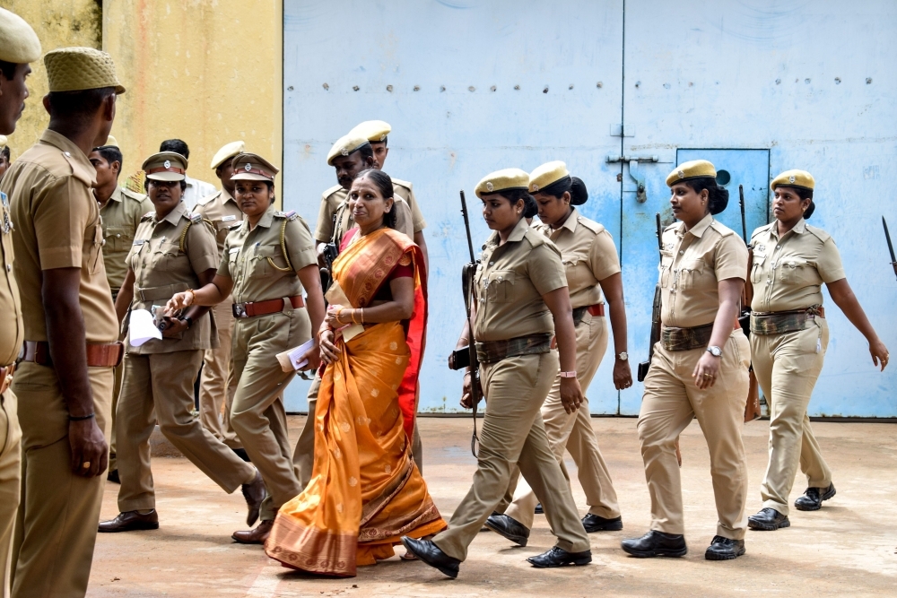 Nalini Sriharan, center in orange, who was convicted in the assassination case of former Prime Minister Rajiv Gandhi, is released from the Vellore Central Prison on a one-month parole to attend her daughter's wedding, in Vellore on Thursday. — AFP