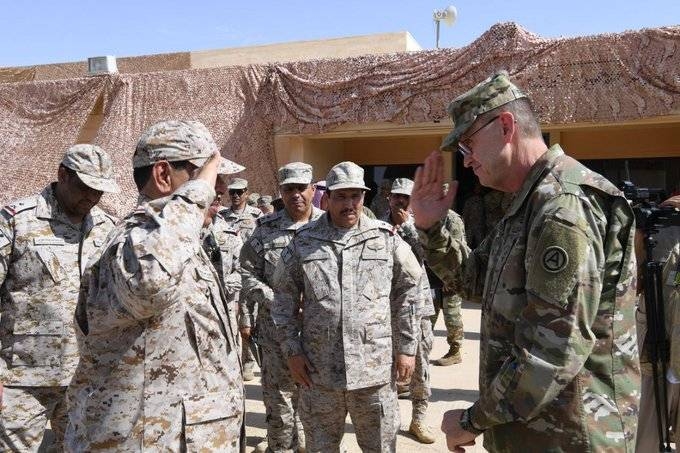 Commander of the Saudi Royal Land Forces Lt. Gen. Fahd Bin Abdullah Al-Mutair congratulating a member of the US forces, which had participated in the joint military exercises with Saudi forces —  