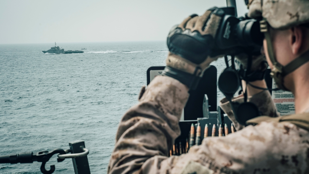 A US Marine observes an Iranian fast attack craft from USS John P. Murtha during a Strait of Hormuz transit, Arabian Sea off Oman, in this picture released by U.S. Navy on July 18, 2019. — Reuters