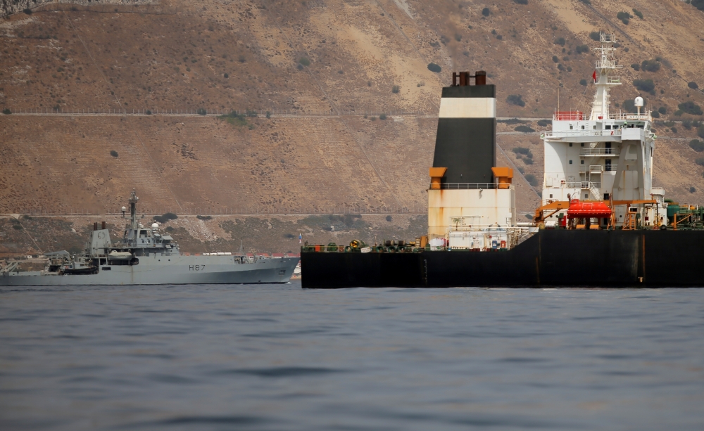 A British Royal Navy patrol vessel guards the Iranian oil tanker Grace 1 as it sits anchored after it was seized earlier this month by British Royal Marines off the coast of the British Mediterranean territory on suspicion of violating sanctions against Syria, in the Strait of Gibraltar, southern Spain, in this July 20, 2019 file photo. — Reuters