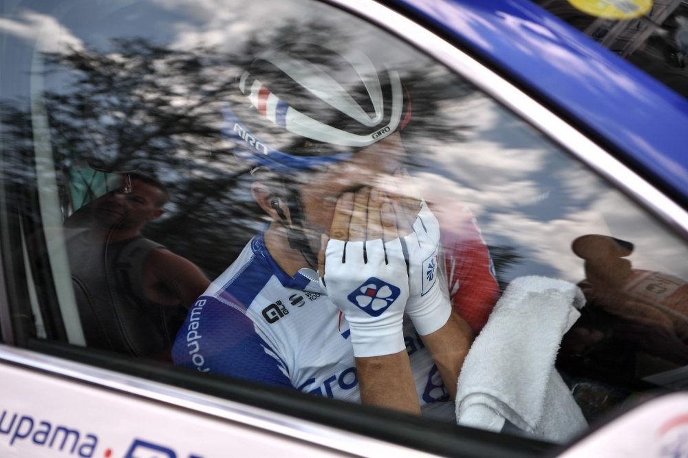 France's Thibaut Pinot (L) is comforted by teammate France's William Bonnet as he stops, forced to quit the Tour due to pain in his left leg during the nineteenth stage of the 106th edition of the Tour de France cycling race between Saint-Jean-de-Maurienne and Tignes, in Tignes, on Friday. — AFP