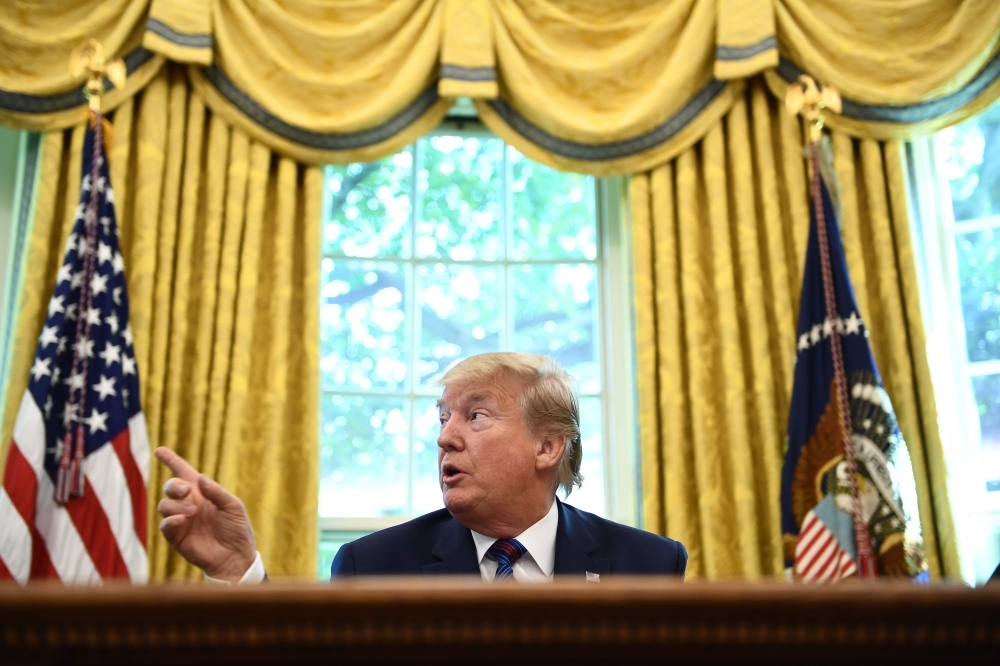 US President Donald Trump speaks to the media in the Oval Office of the White House in Washington, DC on Friday. — AFP