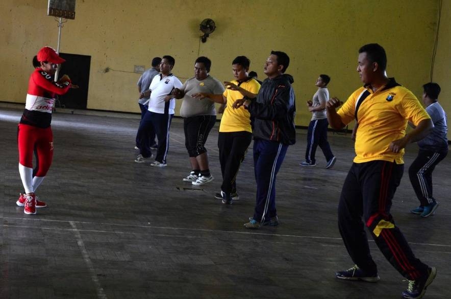 Indonesian police officers perform aerobics during a weight-loss program in Mojokerto, East Java province, Indonesia, on Friday. — Reuters