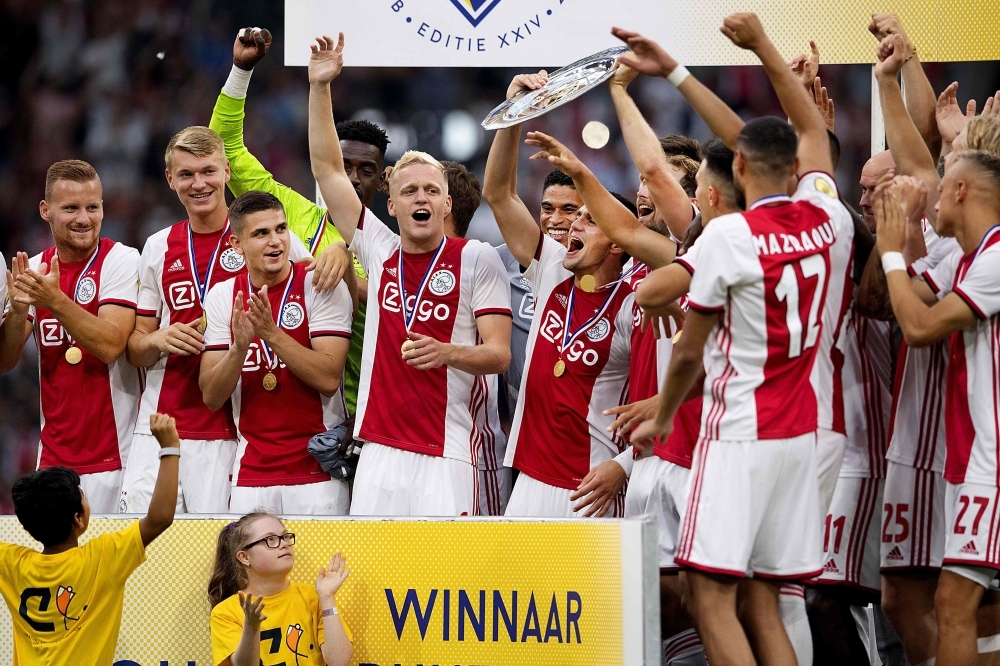 Ajax Amsterdam's players celebrate after winning the Dutch Super Cup football final match between Ajax Amsterdam and PSV Eindhoven at the Johan Cruijff Arena in Amsterdam, on Saturday. — AFP