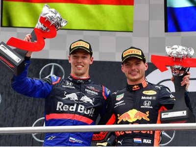 Max Verstappen and Daniil Kvyat pose after winning first and third position respectively. — AFP