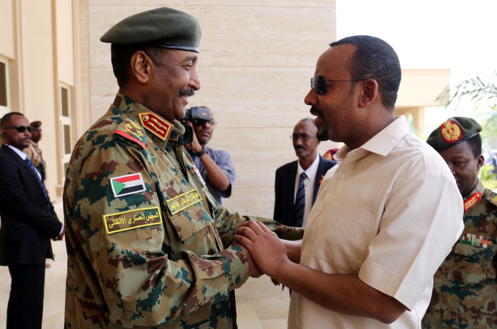 Ethiopian Prime Minister Abiy Ahmed, right, meets Sudan's Head Of Transitional Military Council Lieutenant General Abdel Fattah Al-Burhan, left, to mediate in the political crisis that has followed the overthrow of President Omar Bashir at the airport in Khartoum, Sudan, in this June 7, 2019 file photo. — Reuters