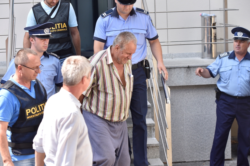 Gheorghe Dinca, 65, is escorted outside the court house in Craiova, Romania, in this July 27, 2019 file photo. — Reuters
