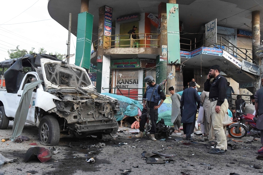 Pakistani police officials examine the site of a bomb explosion in Quetta on Tuesday. — AFP