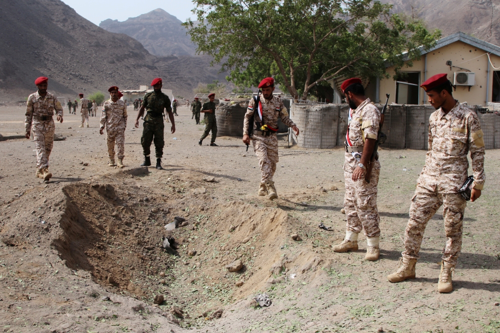 Soldiers are seen at the scene of the blast after a deadly missile attack on a military parade during a graduation ceremony for newly recruited troopers in Aden, Yemen, on Thursday. — Reuters