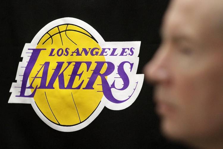 In this file photo taken on Feb. 18, 2013, the Los Angeles Lakers logo is pictured past the profile of Lakers spokesman John Black in El Segundo, California. — Reuters