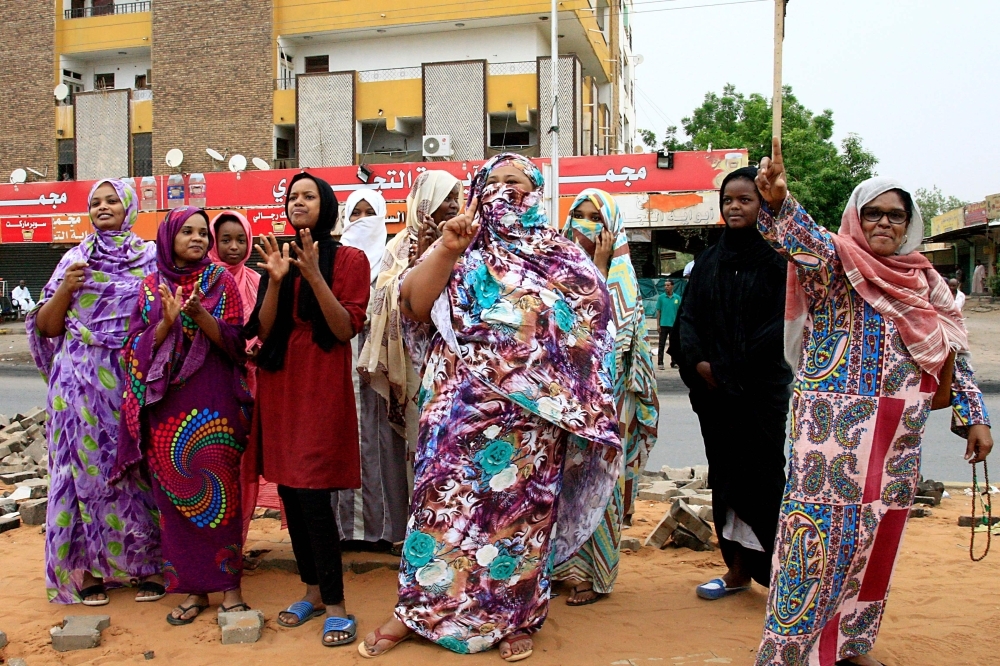 Sudanese celebrate in Khartoum early Saturday, after the ruling generals and protest leaders reached a 