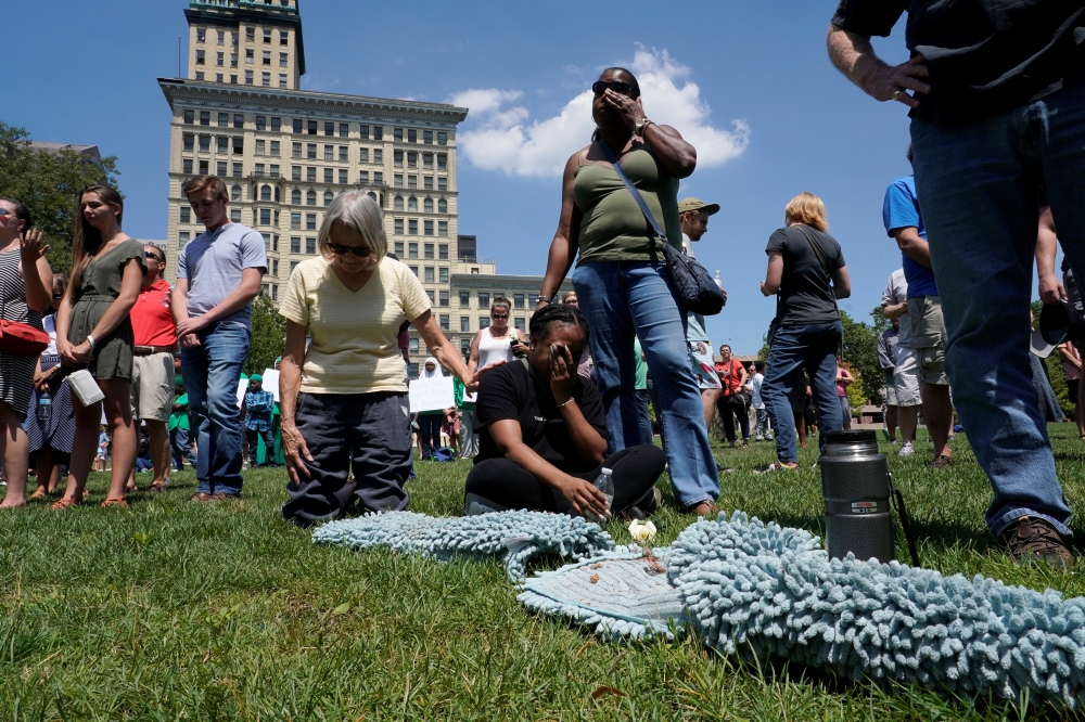 Mourners gather and pray during a vigil after a mass shooting in Dayton, Ohio, US Sunday.  — Reuters